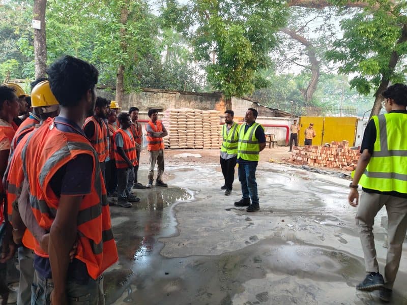 Workers on wet concrete yard